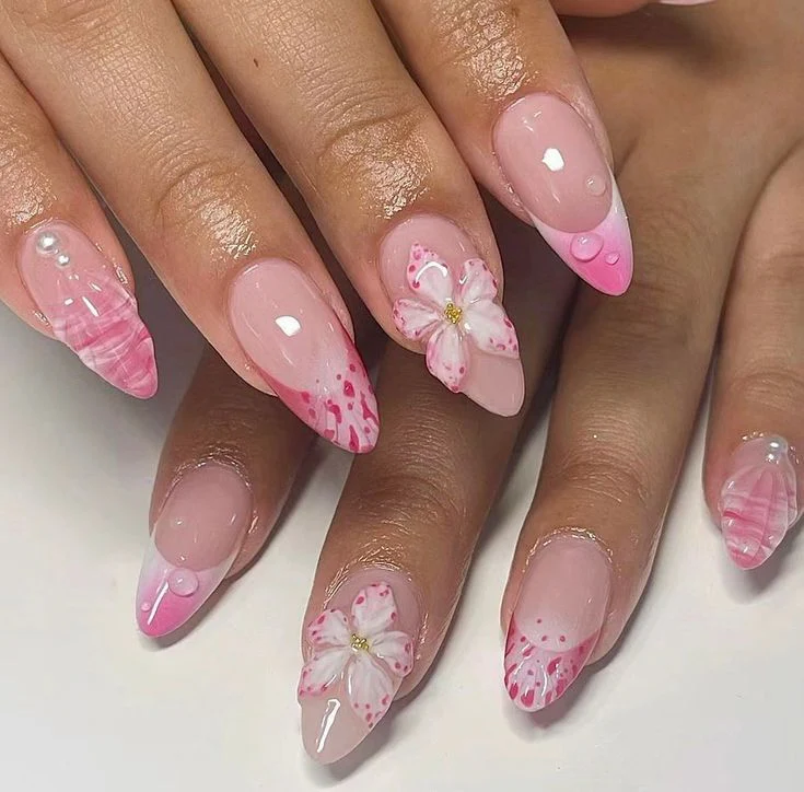 Floral nails designs - elegant coffin pastel flowers - sophisticated hand showcasing pastel base with elegant pastel flower petals, featuring green leaves and stems on coffin-shaped nails